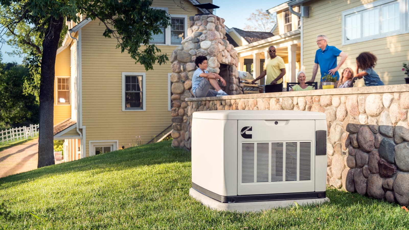Cummins QuietConnect air-cooled home standby generator beside a backyard patio